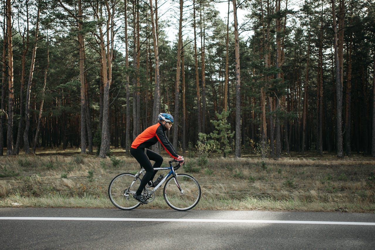 Family cycling on a tree lined traffic free path with meadow views — a typical scene on the Red Squirrel Trail.