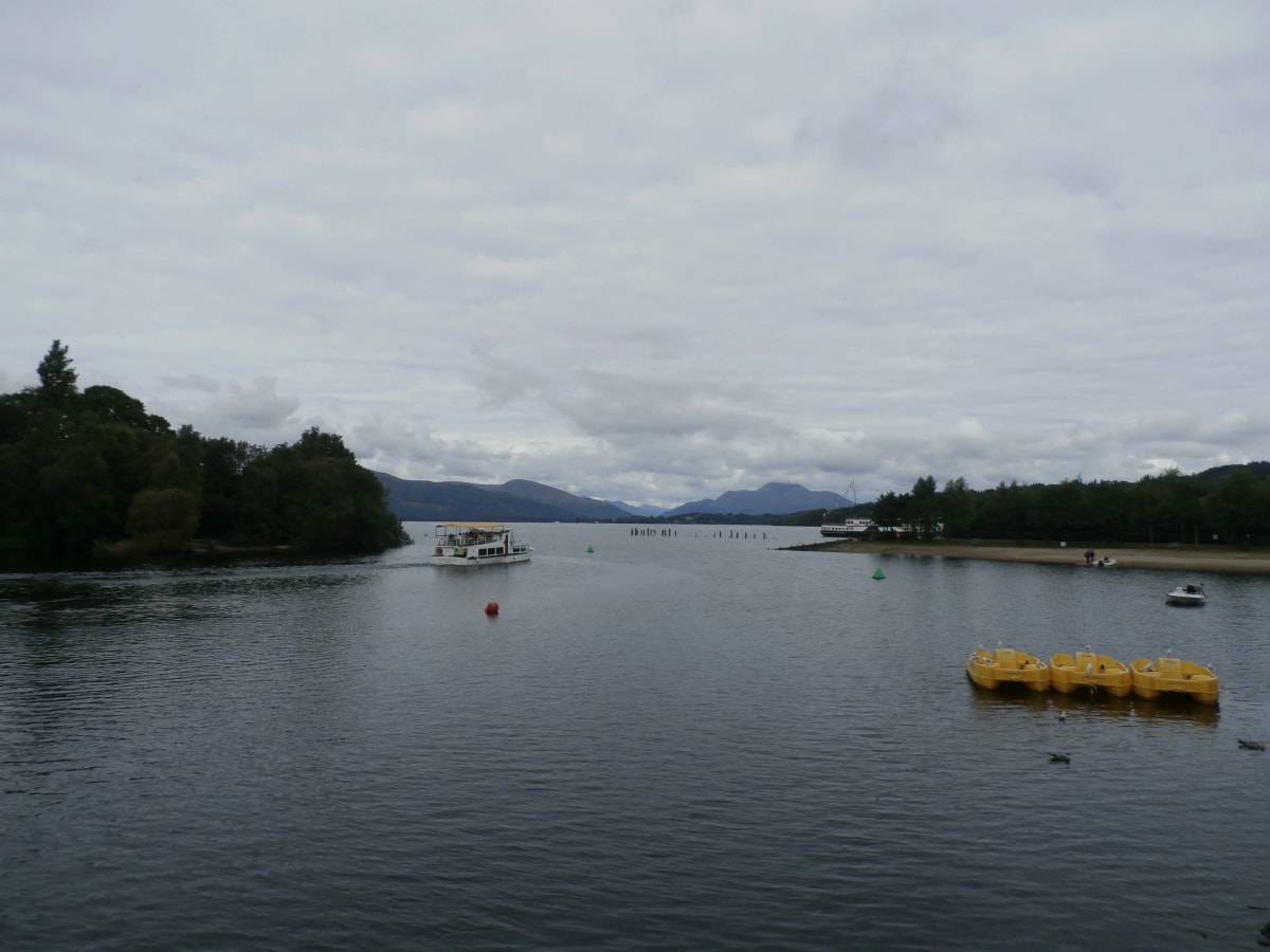 View from Loch Lomond Shores in Balloch up Loch Lomond towards the hills, with boats and buoys on the water